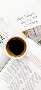 Cup of coffee on papers about passive income streams, perfect for creative work environments.